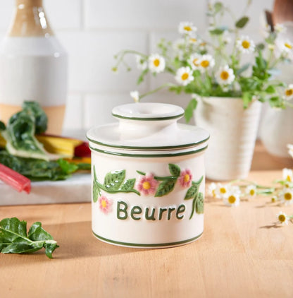 Smørkrukke med vand, blomster